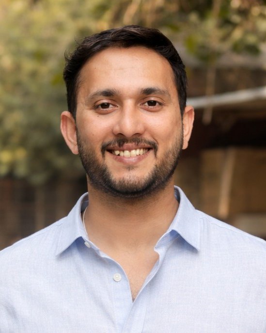 Abhishek Singh, smiling, in a light blue shirt